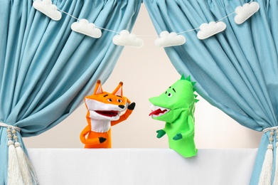 Photo of Creative puppet show on white stage indoors