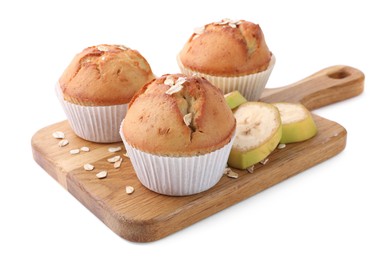 Photo of Wooden board with tasty muffins and banana slices on white background