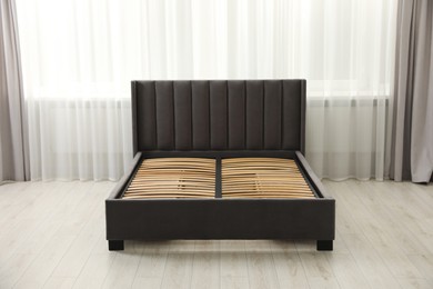 Photo of Modern bed with storage space for bedding under slatted base in room