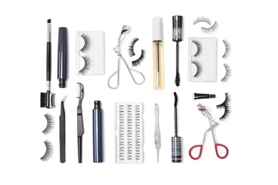 Flat lay composition with false eyelashes and cosmetic tools on white background