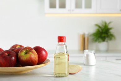 Apple vinegar and baking soda on white marble table in kitchen. Eco friendly natural detergents