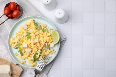 Photo of Delicious scrambled eggs with tofu and lime served on white table, flat lay. Space for yexy