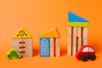 Photo of Set of wooden toys on orange background. Children's development