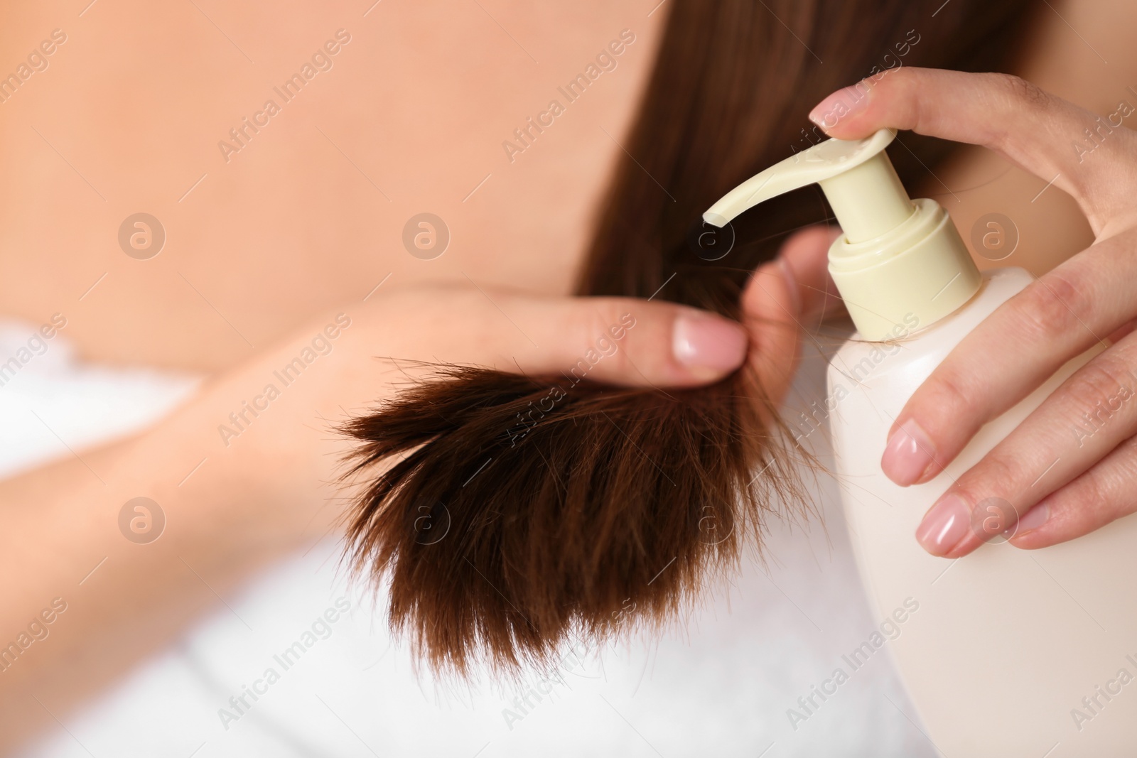 Photo of Woman applying hair conditioner, closeup. Split ends