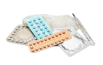 Photo of Contraceptive pills, condoms and thermometer isolated on white. Different birth control methods