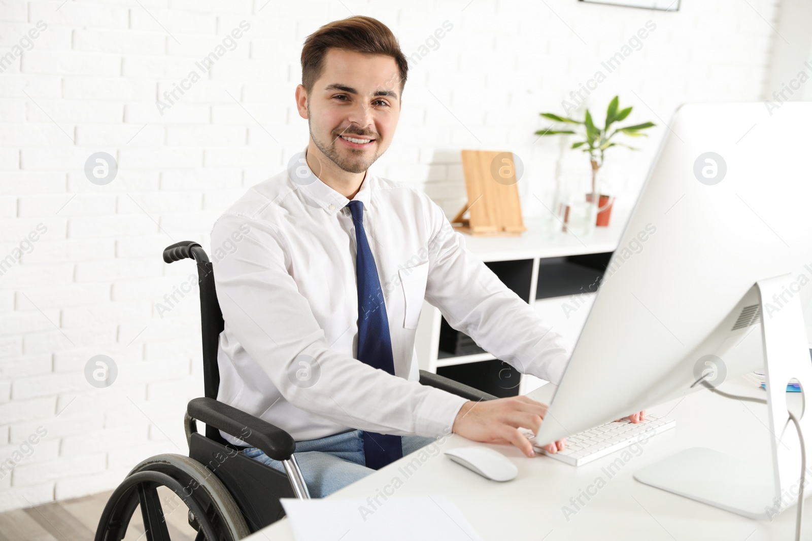 Photo of Portrait of man in wheelchair at workplace