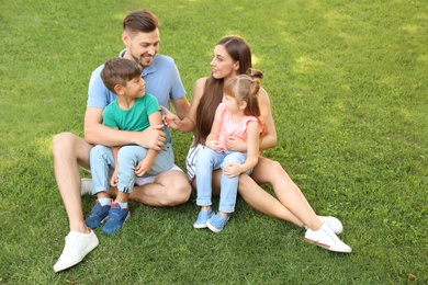 Photo of Happy family with children together in green park on sunny day