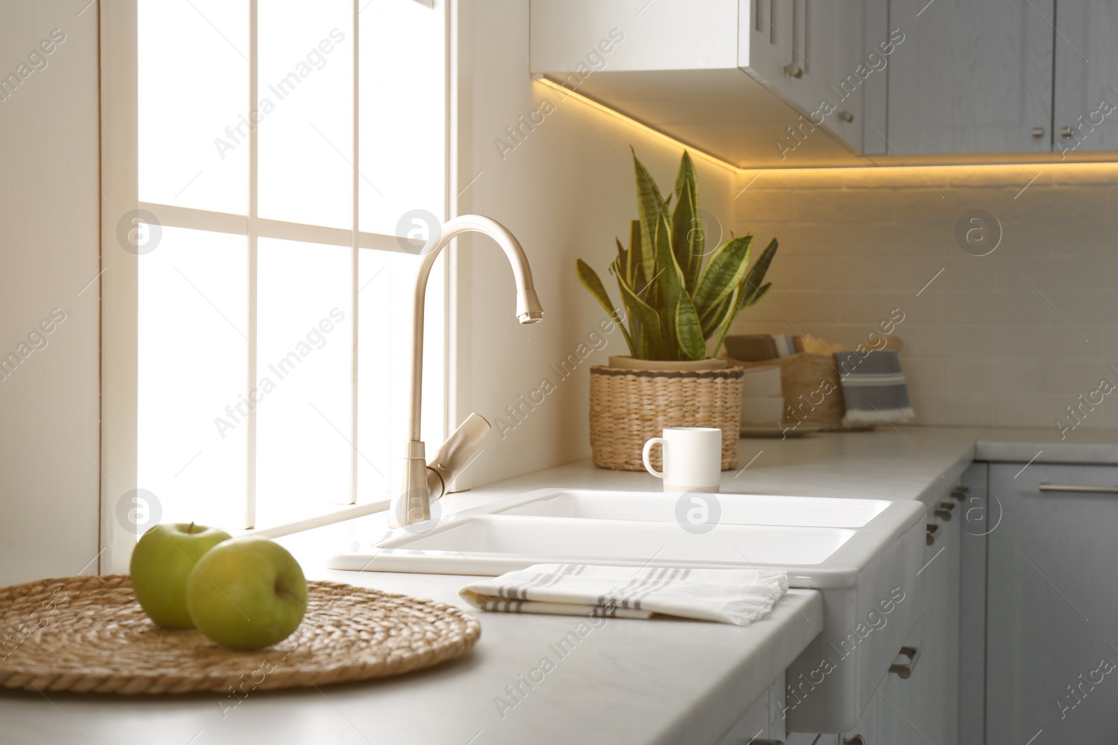 Photo of New ceramic sink and modern tap in stylish kitchen interior