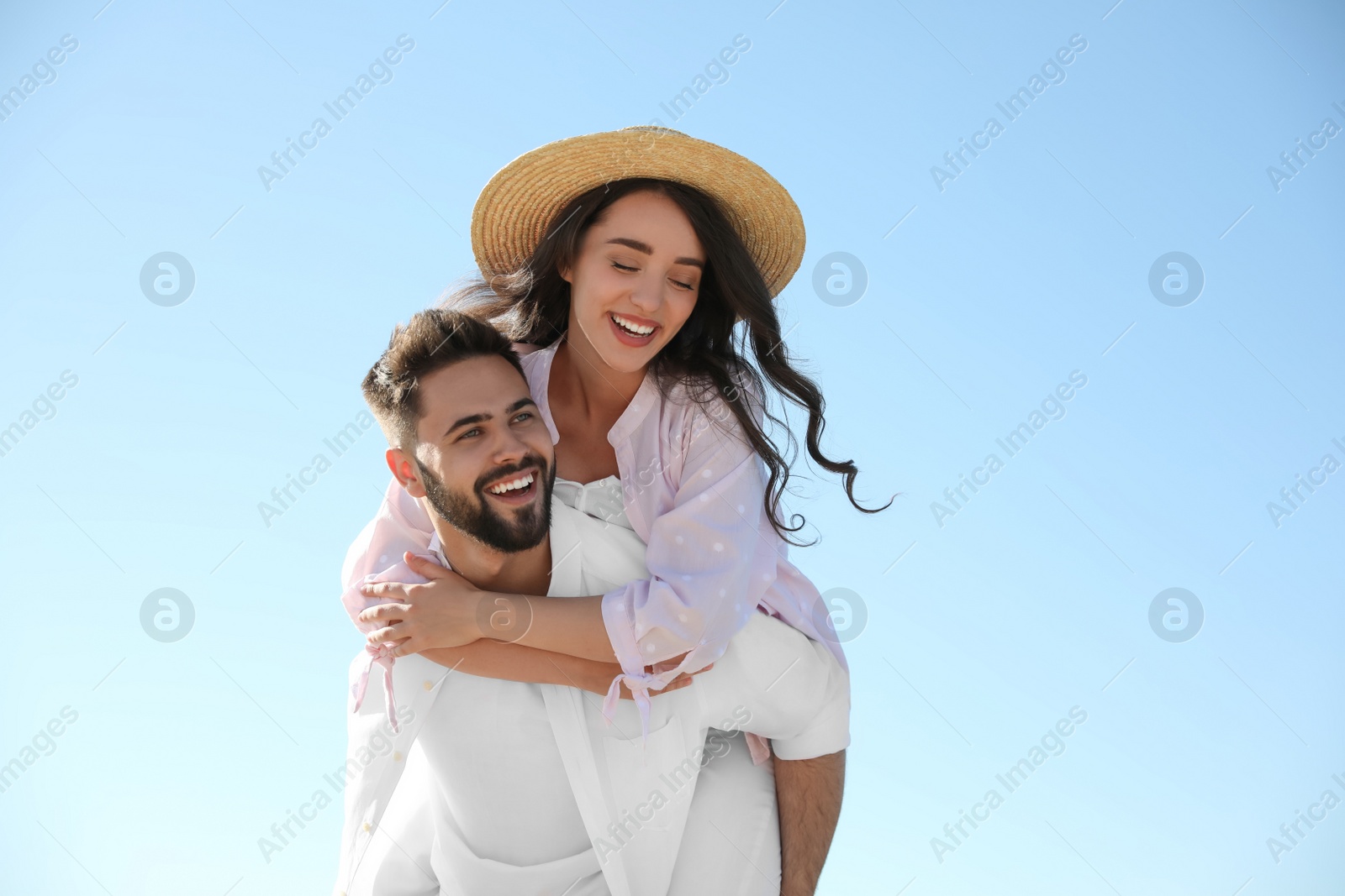 Photo of Happy young couple having fun against blue sky. Honeymoon trip