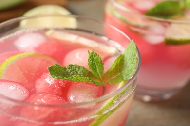 Photo of Tasty refreshing watermelon drink on table, closeup