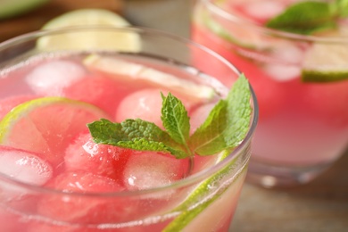 Tasty refreshing watermelon drink on table, closeup