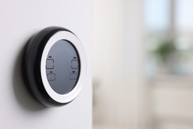 Photo of One thermostat on white wall indoors, space for text. Smart home system