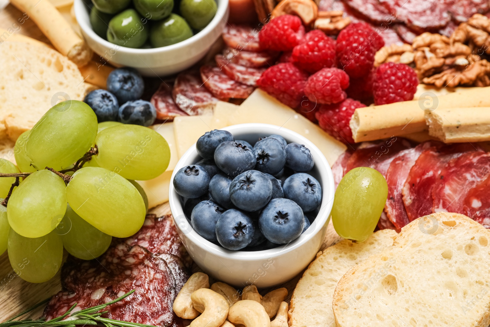 Photo of Tasty parmesan cheese and other different appetizers as background, closeup