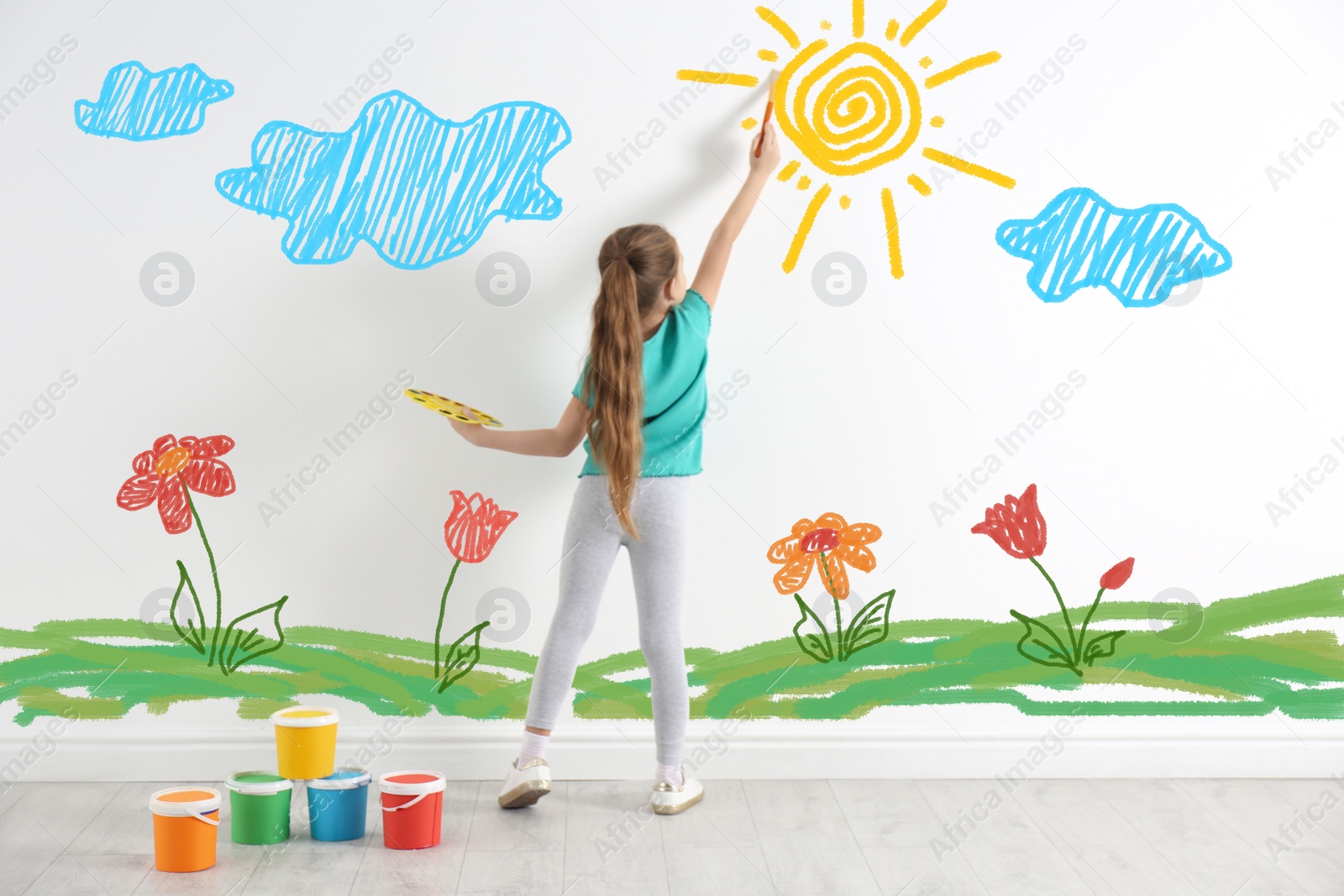 Image of Cute child drawing nature on white wall indoors