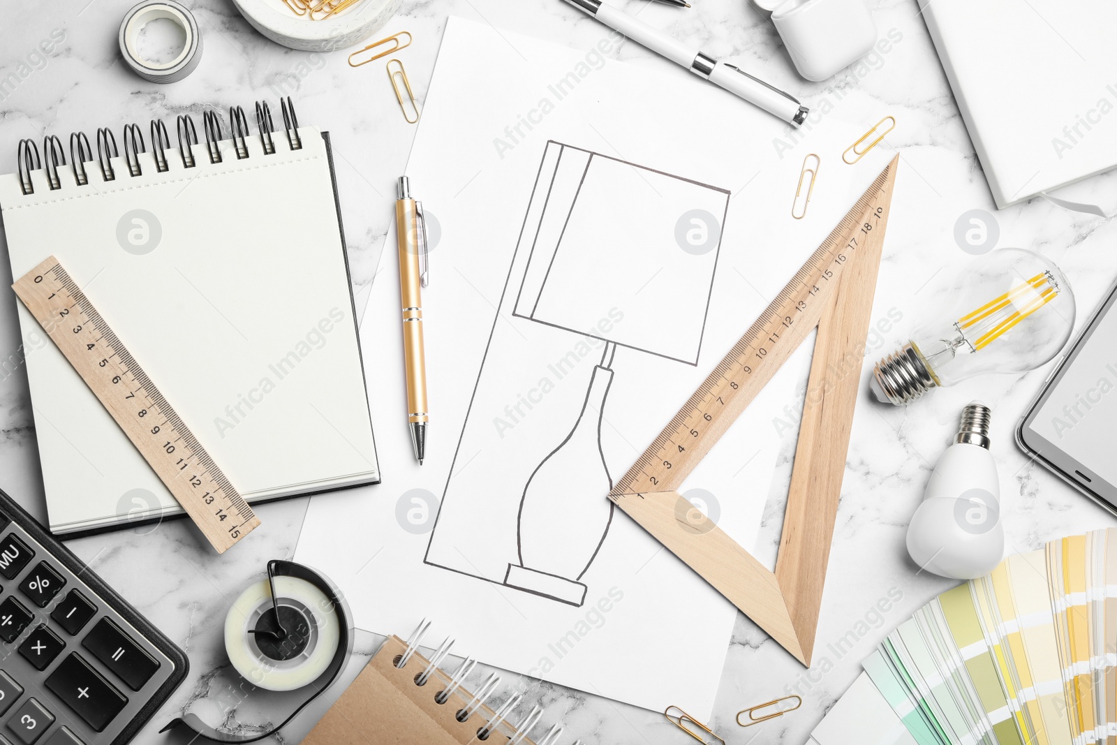 Photo of Flat lay composition with drawing of lamp on white marble table. Designer's workplace