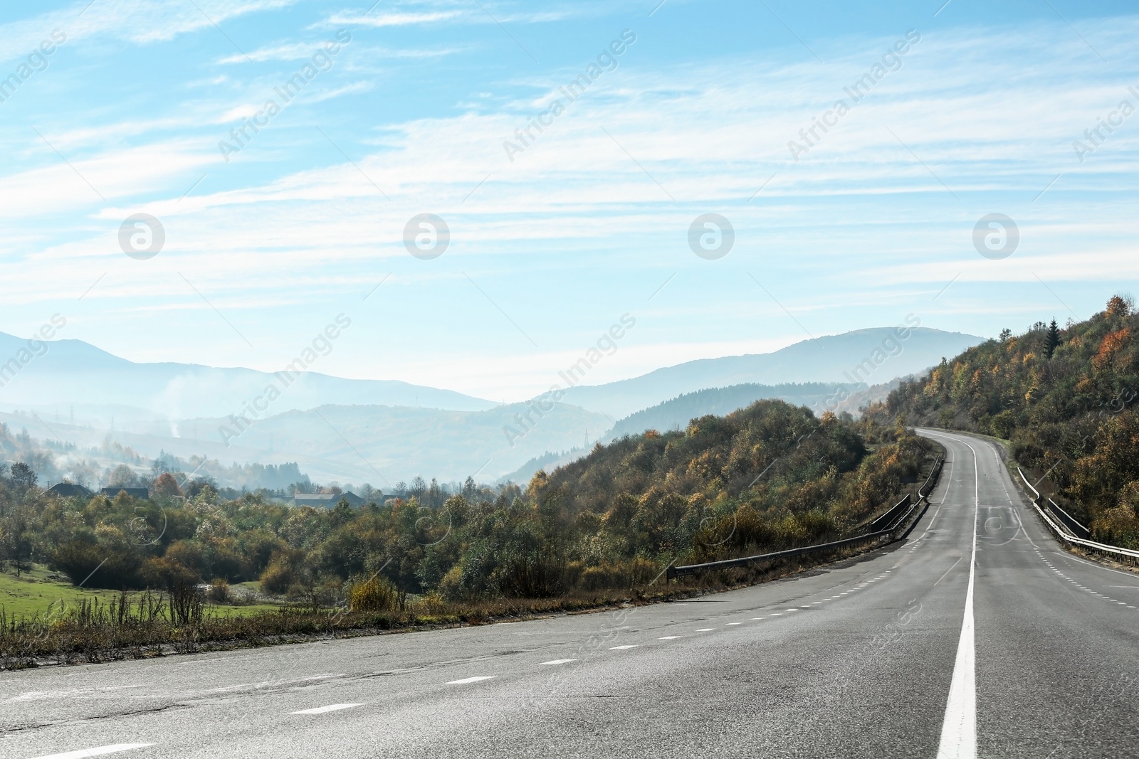 Photo of Landscape with asphalt road leading to mountains