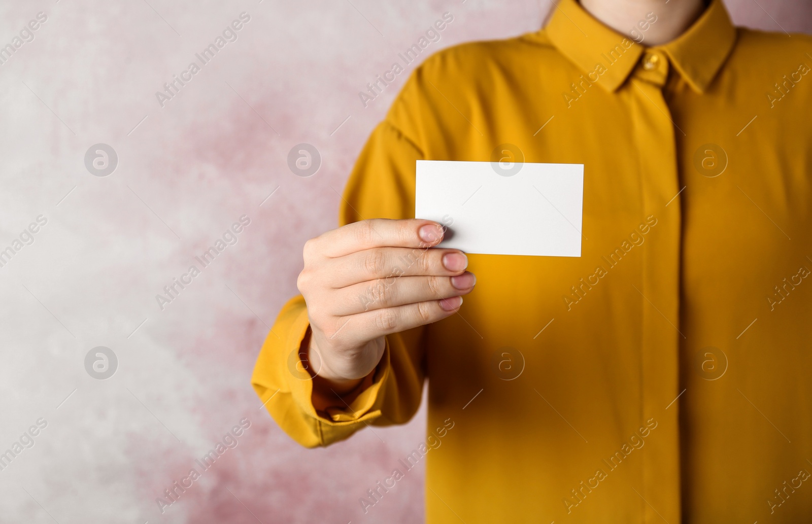 Photo of Woman holding blank business card on pink background, closeup. Mockup for design