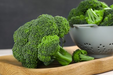 Fresh raw broccoli on wooden board, closeup