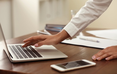 Business trainer working at table in office, closeup