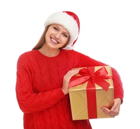 Happy young woman in Santa hat with Christmas gift on white background