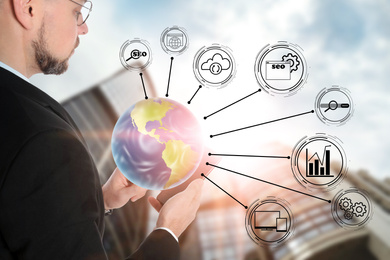 Image of Man demonstrating directions of SEO. World globe with icons of keyword research, customization and others