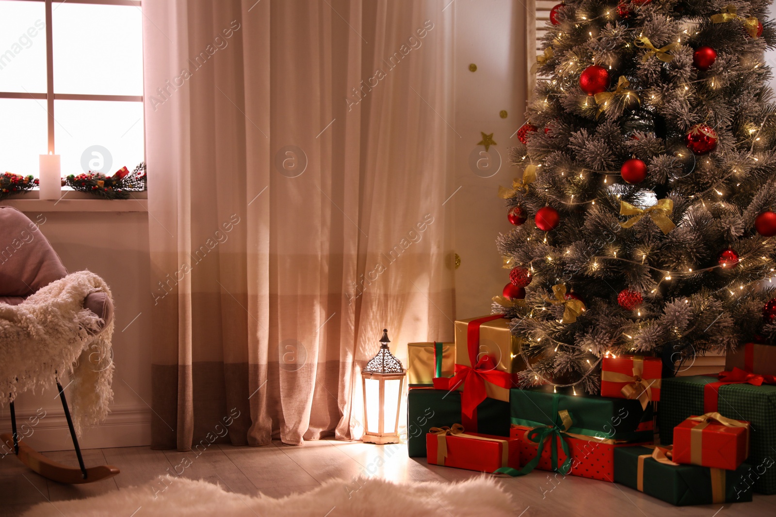 Photo of Stylish room interior with beautiful Christmas tree and gift boxes