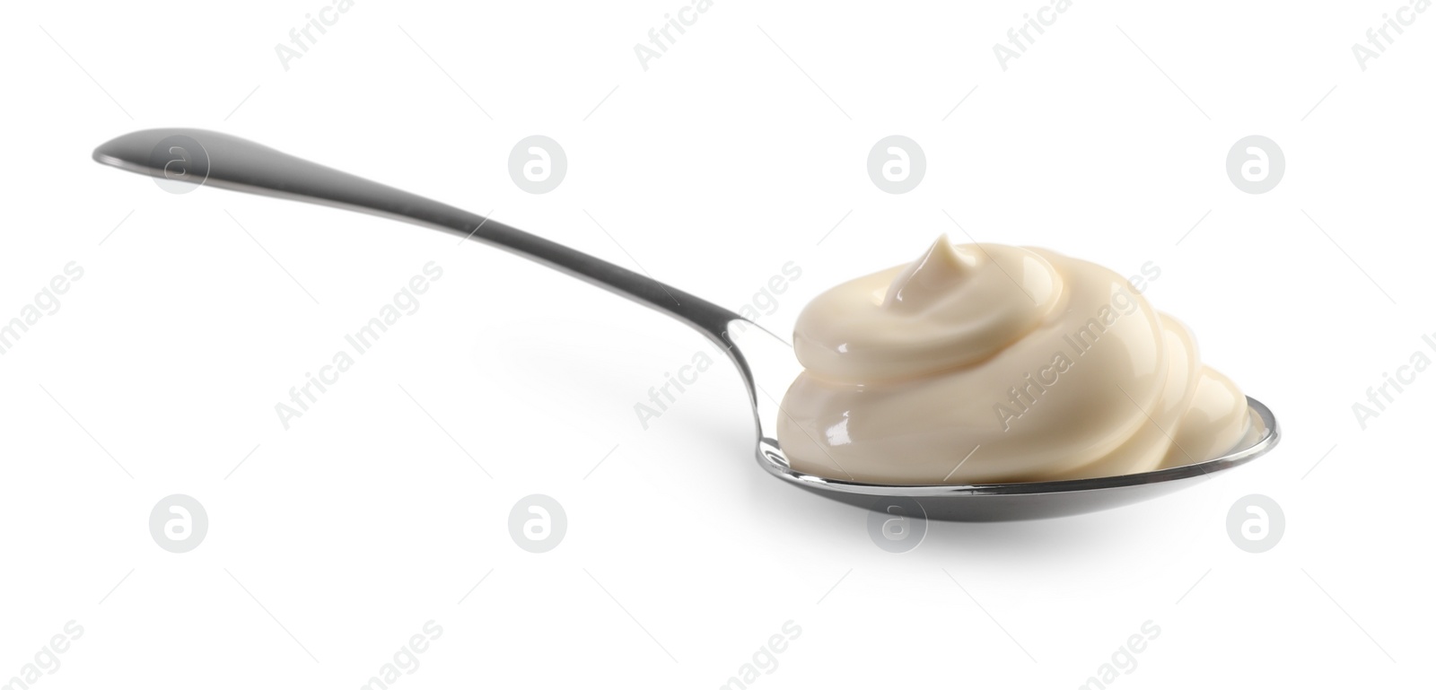 Photo of Natural yogurt in spoon isolated on white