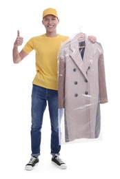 Dry-cleaning delivery. Happy courier holding coat in plastic bag and showing thumbs up on white background