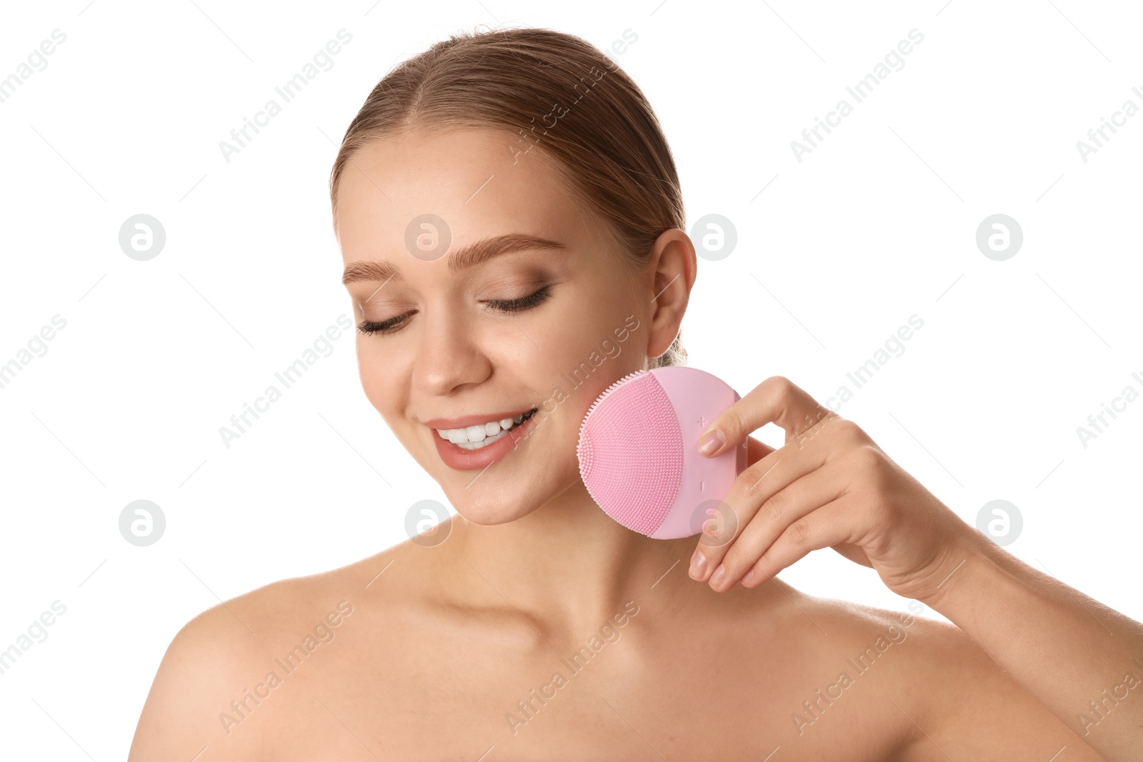 Photo of Young woman washing face with cleansing brush on white background. Cosmetic product