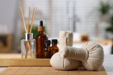 Photo of Spa composition with herbal bags on white table indoors, selective focus