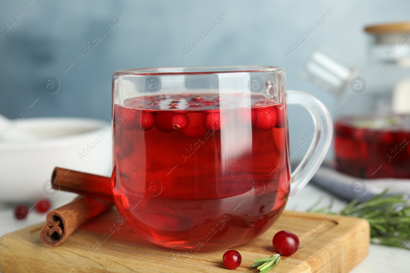 Photo of Tasty hot cranberry tea and fresh ingredients on white table