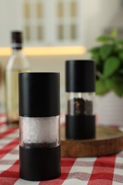 Photo of Salt and pepper shakers on table indoors