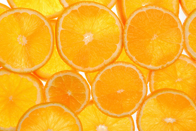 Photo of Slices of fresh tangerines as background, top view