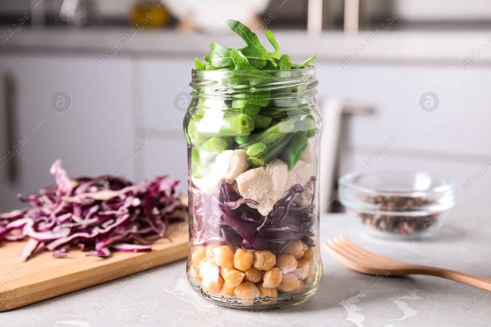 Photo of Glass jar with healthy meal on light grey marble table