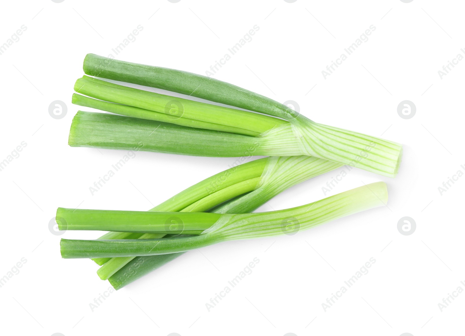 Photo of Fresh green spring onions isolated on white, top view