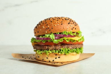 Photo of Burger with delicious patty on light table
