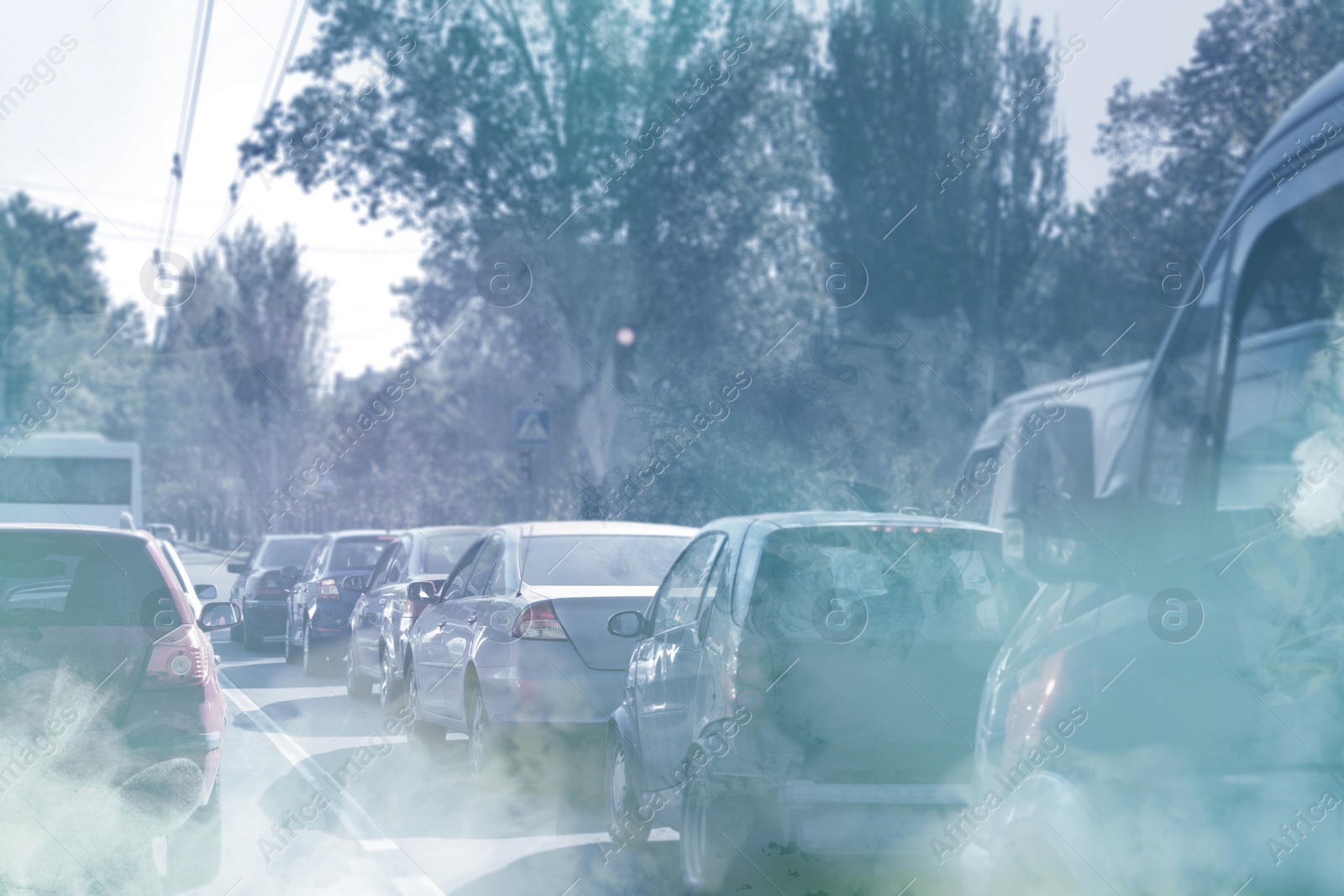 Image of Environmental pollution. Air contaminated with fumes in city. Cars surrounded by exhaust on road