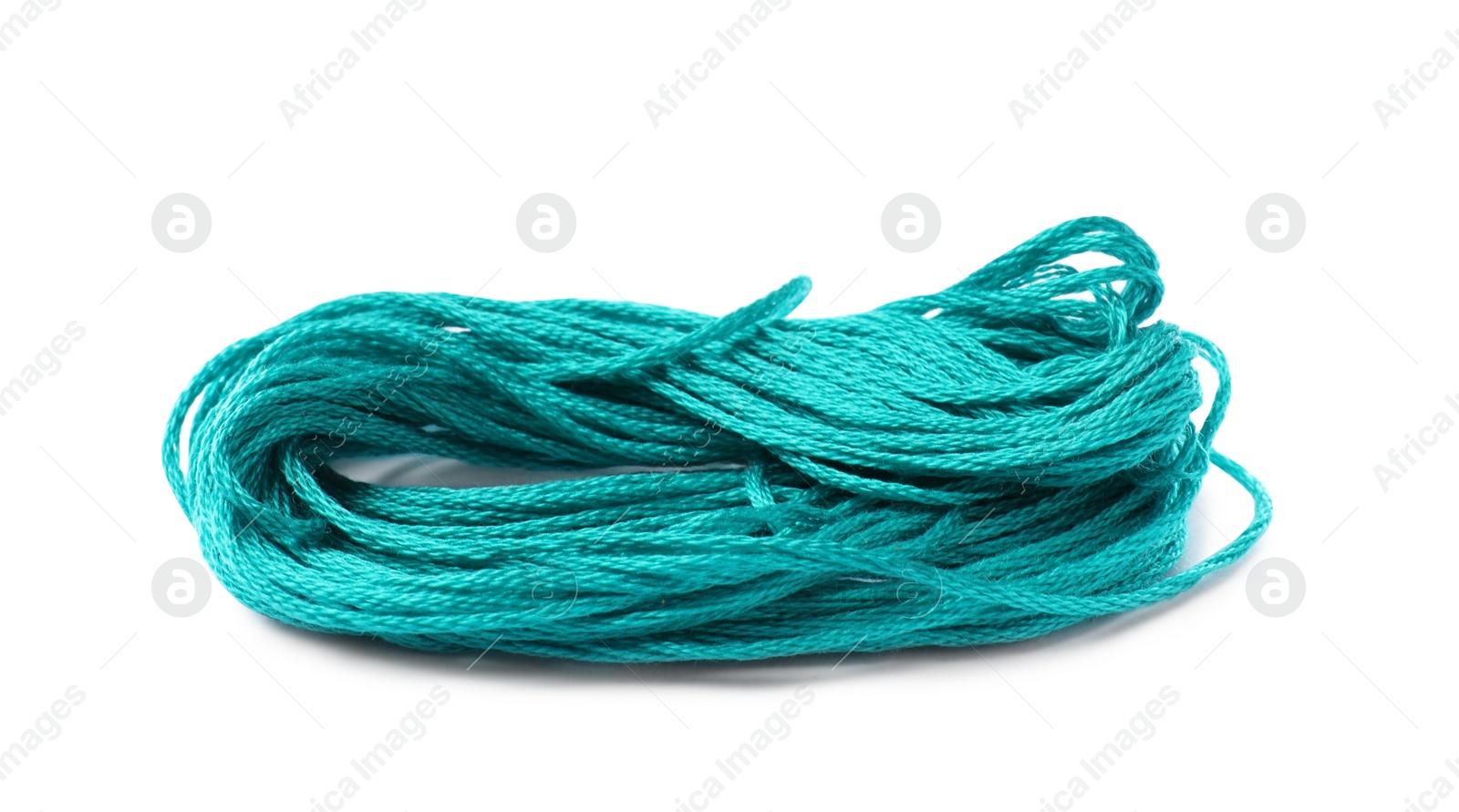 Photo of Bright turquoise embroidery thread on white background