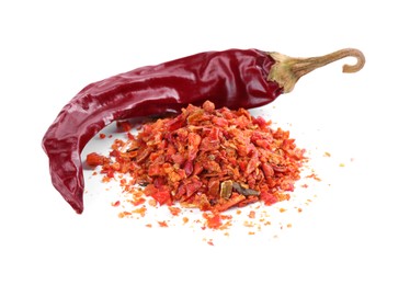 Photo of Aromatic spice. Pile of red chili pepper flakes and pod isolated on white