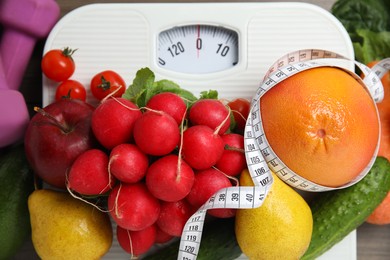 Photo of Fresh healthy food on scales, top view