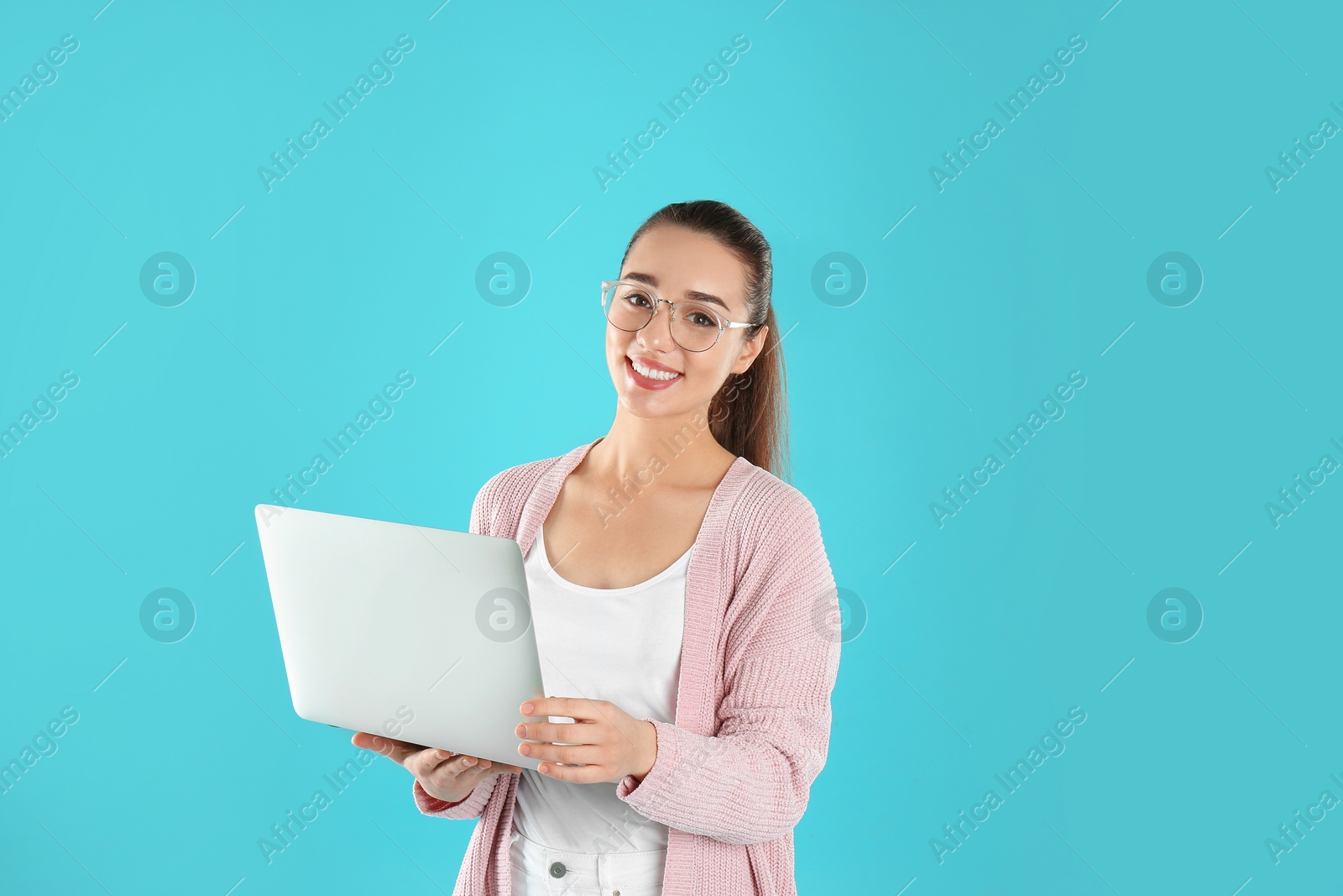 Photo of Portrait of young woman in casual outfit with laptop on color background