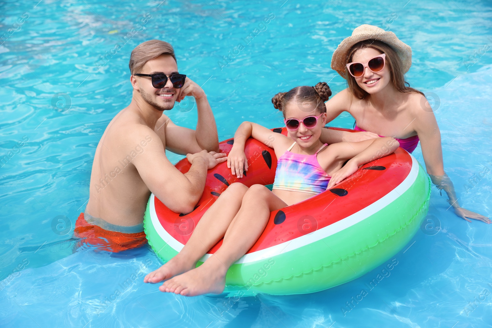 Photo of Happy family in pool on sunny day