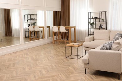 Photo of Modern living room with parquet flooring and stylish furniture