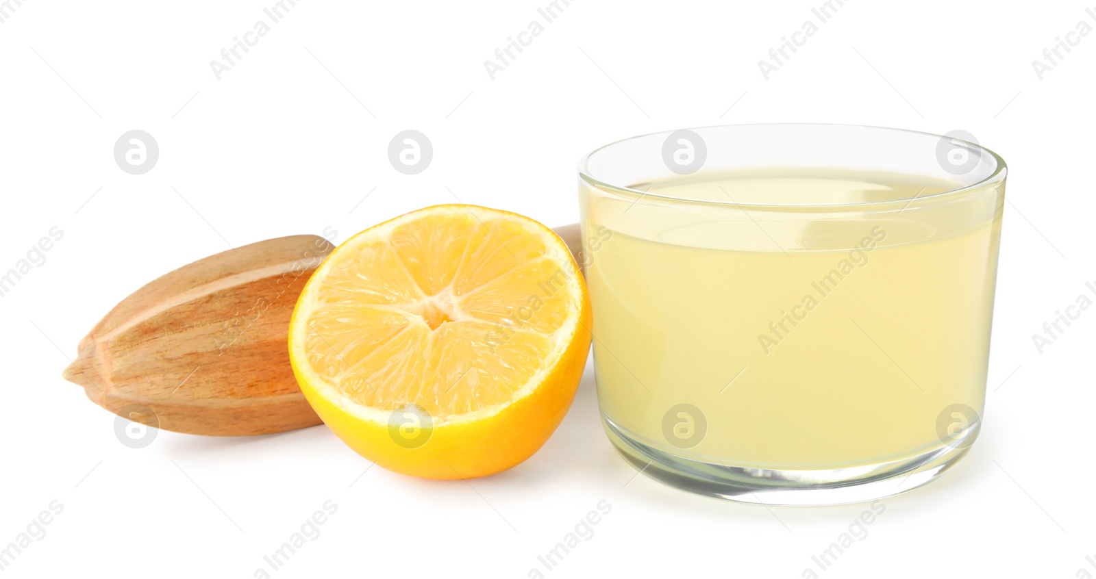 Photo of Freshly squeezed juice, half of lemon and reamer on white background