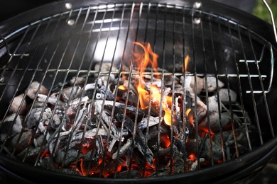 Photo of New modern barbecue grill with coals, closeup