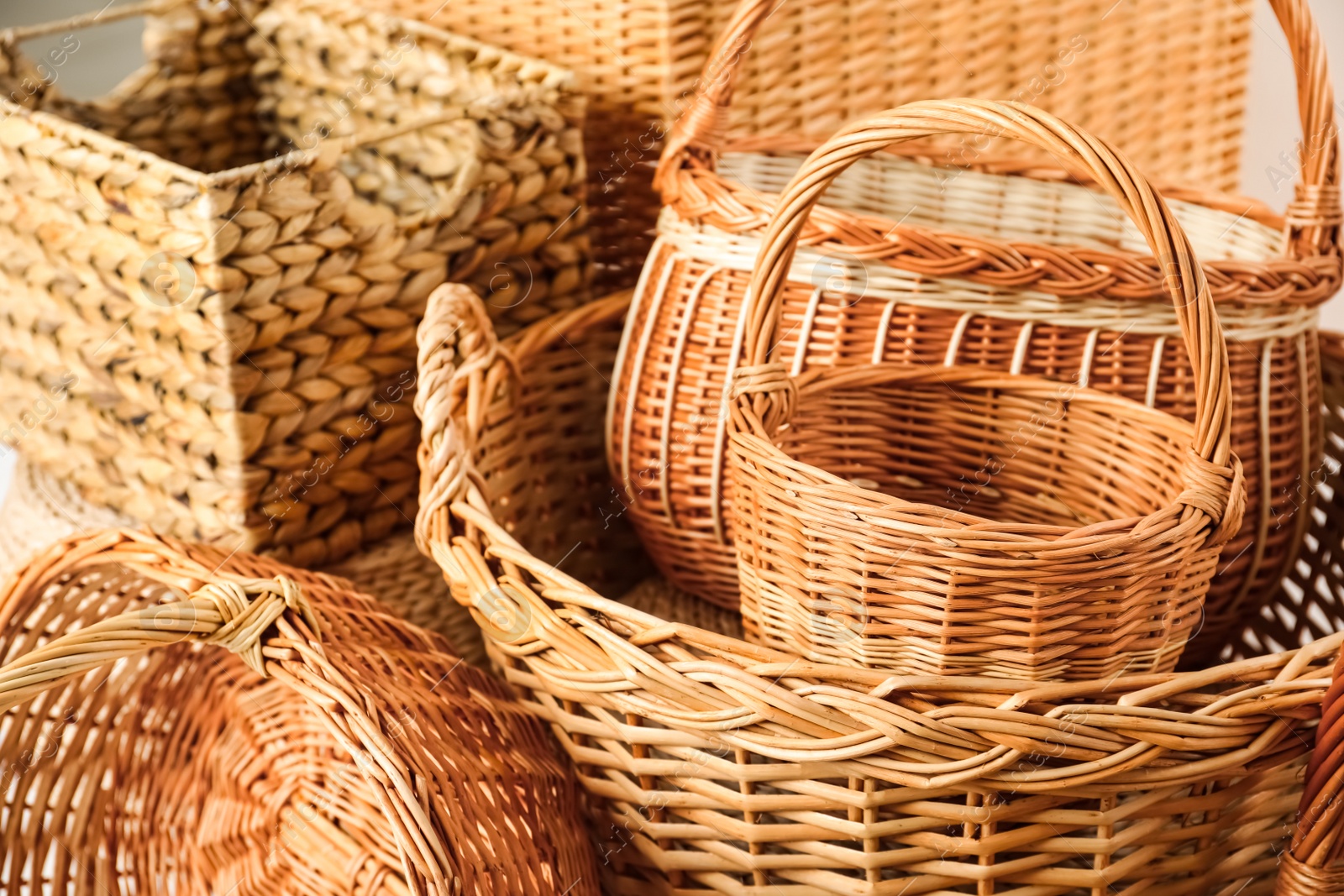 Photo of Many different wicker baskets made of natural material as background