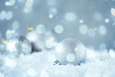 Greeting card design with beautiful Christmas ball and snowflakes, bokeh effect