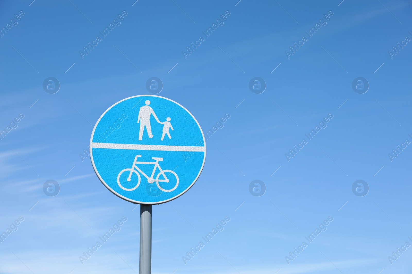 Photo of Traffic sign Compulsory Track For Pedestrians and Bicycles against blue sky