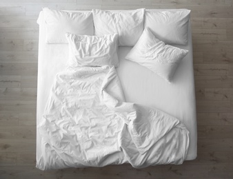 Photo of Comfortable bed with soft pillows indoors, top view