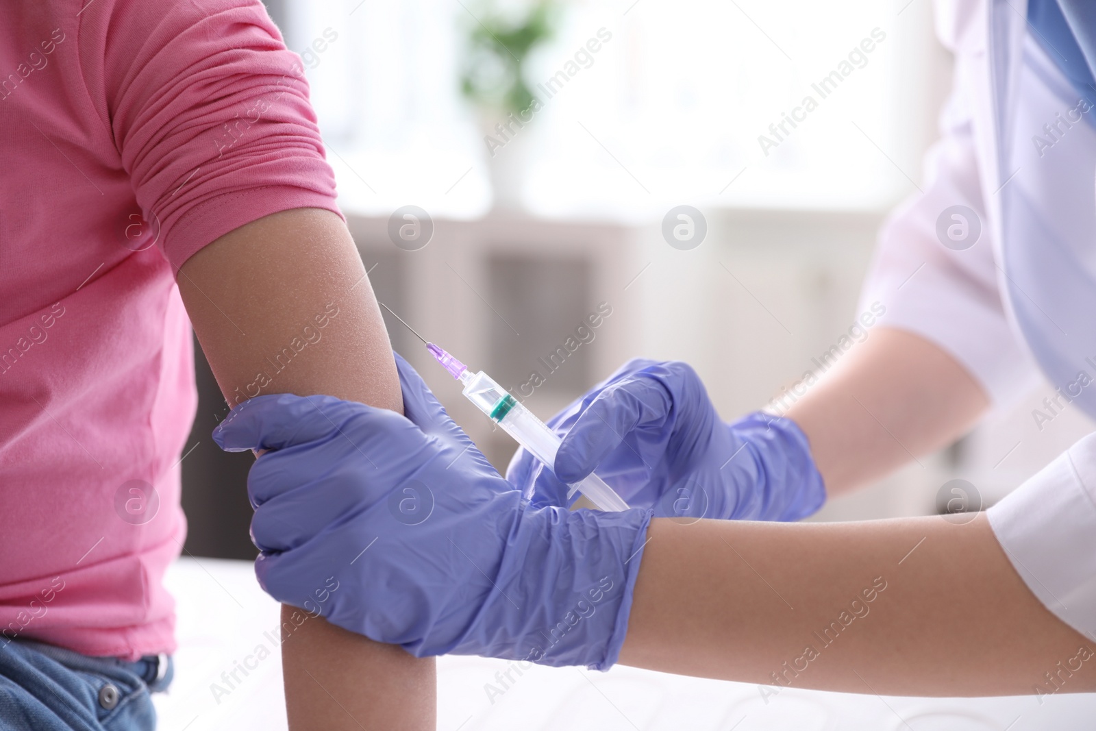 Photo of Little girl receiving chickenpox vaccination in clinic, closeup. Varicella virus prevention